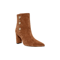 A brown buckskin suede “Theodora Block-Heel Bootie” featuring a pointed toe, chunky block heel, and three decorative gold buttons along the side, photographed against a plain white background.