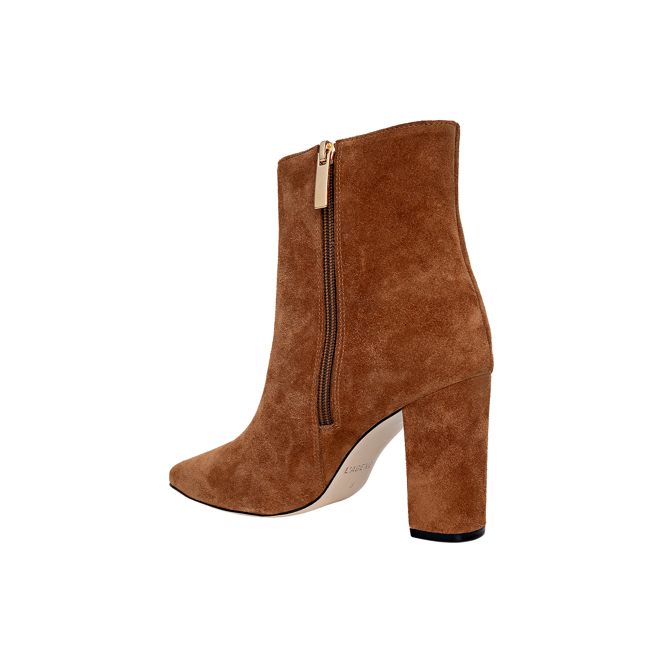 The Theodora Block-Heel Bootie is a tan buckskin suede high-heeled ankle boot featuring a pointed toe, sturdy block heel, and convenient side zipper, shown against a plain white background.