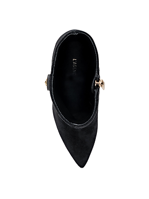 Top view of Theodora Block-Heel Bootie in black suede, featuring a pointed toe and gold buckle detail on the side. LA FEMME branding is visible inside the shoe, all set against a white background.