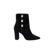 The Theodora Block-Heel Bootie features black suede construction, a pointed toe, a sturdy block heel, and three gold decorative buttons on the outer side. It is displayed against a plain light gray background.