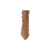 The Theodora Block-Heel Bootie, a brown suede ankle boot featuring a pointed toe and chic block heel, is displayed from the front against a plain white background.