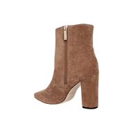 The Theodora Block-Heel Bootie is shown in tan suede with a chunky block heel, pointed toe, and a side zipper. Photographed against a plain white background, the bootie is displayed from a side profile view.
