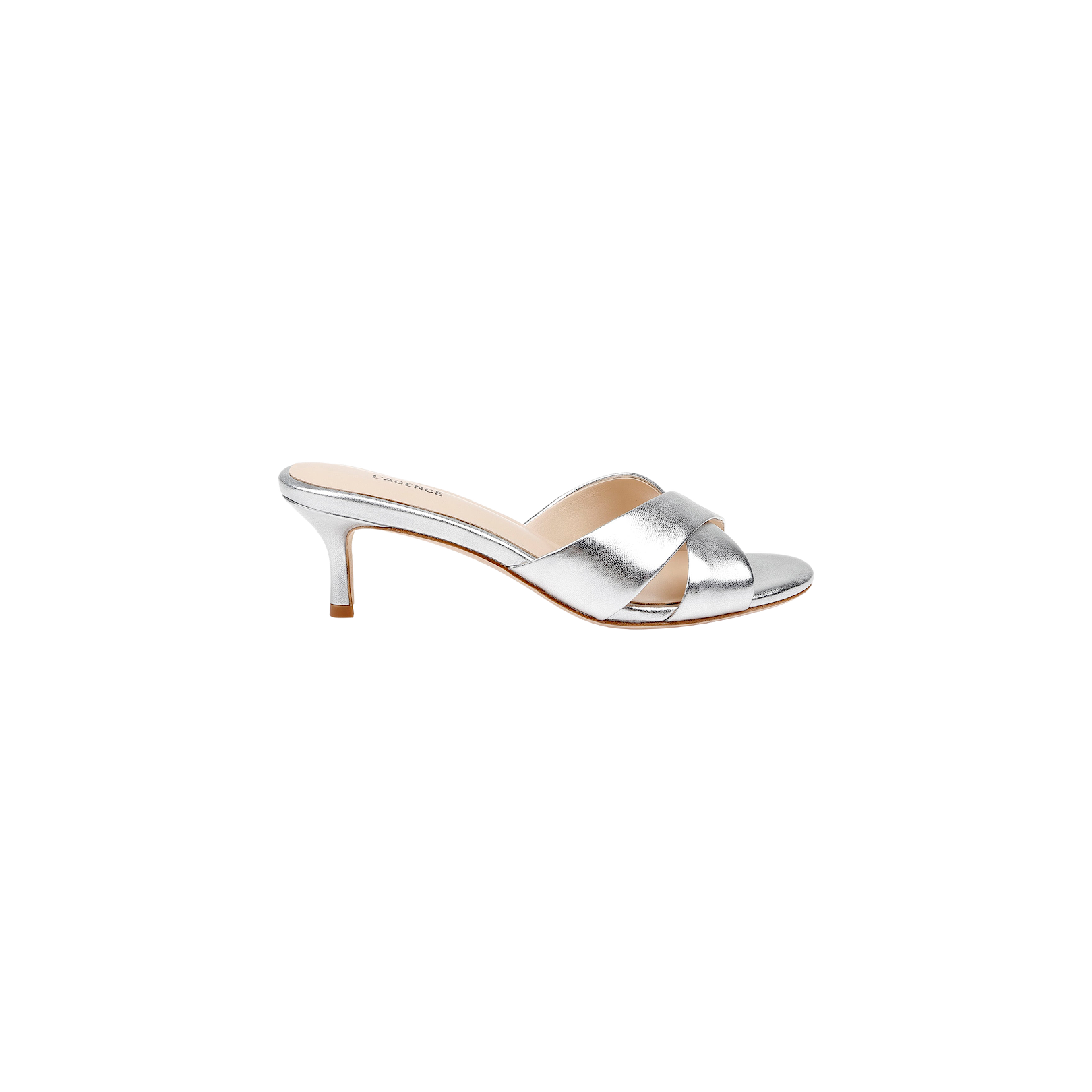 The Aveline Kitten-Heel Sandal is crafted from metallic silver leather and features crisscross straps, an open toe, and a chic kitten heel. Shown in profile view against a plain white background.