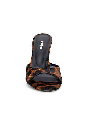 The Avery Open-Toe Mule is a sculpted stiletto with an open toe and bold brown and black leopard hair calf upper, finished with a black insole labeled “L’AGENCE.”.