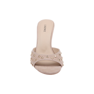 The Avery Embellished Mule is a tan suede open-toe sandal featuring gold stud accents on its wide strap and a low, flared heel, shown from the front against a plain white background.