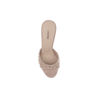 The Avery Embellished Mule, an open-toe sandal crafted from tan suede with gold studs adorning the upper strap, is shown from above against a white background. The insole displays the LAGENCE label.