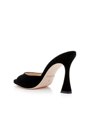 The Avery Suede Open-Toe Mule is a black sandal with a sculpted stiletto flared heel, shown on a white background and angled to highlight its sleek side and back design.