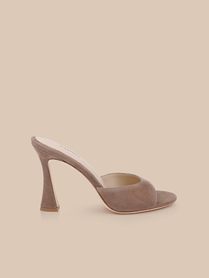 The Avery Suede Open-Toe Mule, featuring a single tan suede design with a sculpted high heel and memory foam insole, is displayed on a plain beige background.