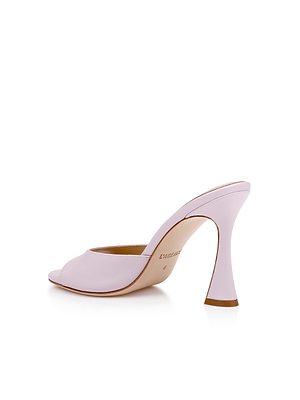 The Avery Leather Open-Toe Mule is a pastel lilac shoe with a sculpted flared heel, beige insole, and subtle branding, shown on a white background.