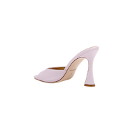 The Avery Leather Open-Toe Mule, crafted in pale pink leather, features an open toe and a sculpted, curved heel; it is displayed in profile against a white background.