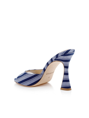 The Avery Open-Toe Mule features blue striped denim, a flared curved high heel, and an open-toe design, shown from the back and side on a white background.