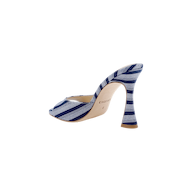 The Avery Open-Toe Mule is a denim high-heeled mule with a flared heel, featuring blue and white diagonal stripes and an open-toe design, shown on a white background.