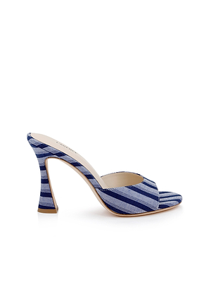 The Avery Open-Toe Mule showcases blue striped denim in diagonal patterns, a wide front strap, and a flared curved heel with an open-toe design, displayed against a white background.