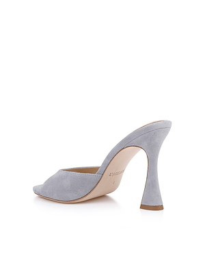 The Avery Suede Open-Toe Mule is shown in pale blue suede, featuring an open back, pointed toe, and flared sculpted high heel in a three-quarter rear view on a white background.