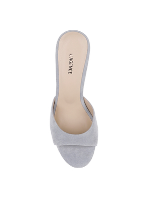 A top view of the Avery Suede Open-Toe Mule in light grey, featuring a wide strap, beige memory foam insole, and LAGENCE branding on the footbed. The sandal is shown against a white background.
