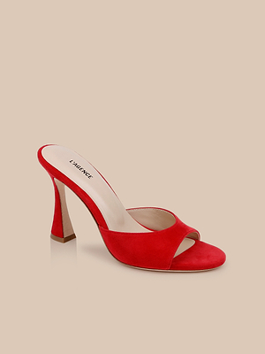 The Avery Suede Open-Toe Mule is a single red suede shoe with an open toe and sculpted heel, shown on a beige background. Its light insole displays the L’AGENCE brand name.