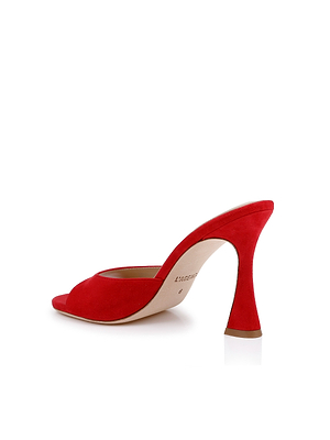 The Avery Suede Open-Toe Mule, shown against a white background, features red suede, an open toe, a sculpted stiletto heel, and a comfortable memory foam insole.
