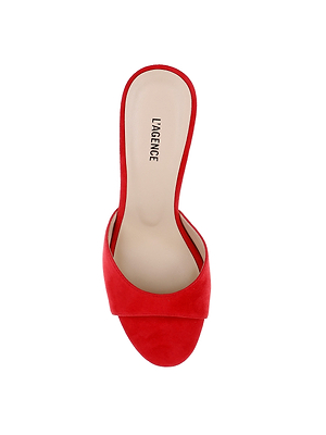 The Avery Suede Open-Toe Mule features a red suede design with a single wide strap and a beige memory foam insole labeled LAGENCE, shown on a white background.