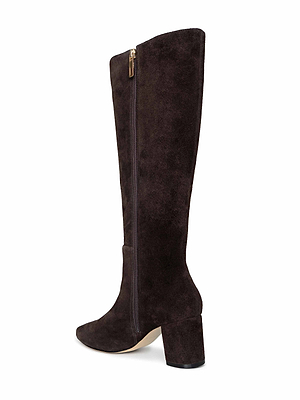 The Eugenie Block-Heel Boot is a tall, dark brown suede boot featuring a mid-height block heel and side zipper, shown from an angle to highlight the outer side and back—ideal for stylish fall-to-winter wear.