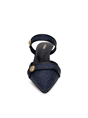 A single dark blue Gilliane Heeled Mule by L'AGENCE with two straps, lion-embossed buttons, a pointed toe, and a black insole bearing the brand name. The shoe is shown front-facing on a white background.