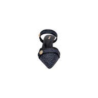 Introducing the Gilliane Heeled Mule: a single dark blue denim mule with a pointed toe, featuring a strap across the front and another around the ankle, both embellished with round lion-embossed buttons. The shoe is finished with a black insole accented by gold text, enhancing its vintage mule allure.
