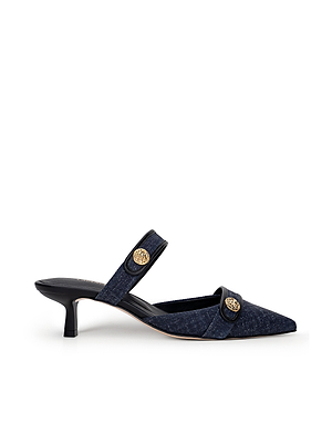 The L'AGENCE Gilliane Heeled Mule features a navy blue vintage design with a pointed toe, low kitten heel, two foot straps, and gold-tone lion-embossed buttons.
