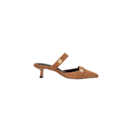 The Gilliane Heeled Mule features tan suede, a pointed toe, mid-height heel, a strap across the top, and decorative lion-embossed buttons on the side. These vintage-inspired mules are displayed on a plain white background.