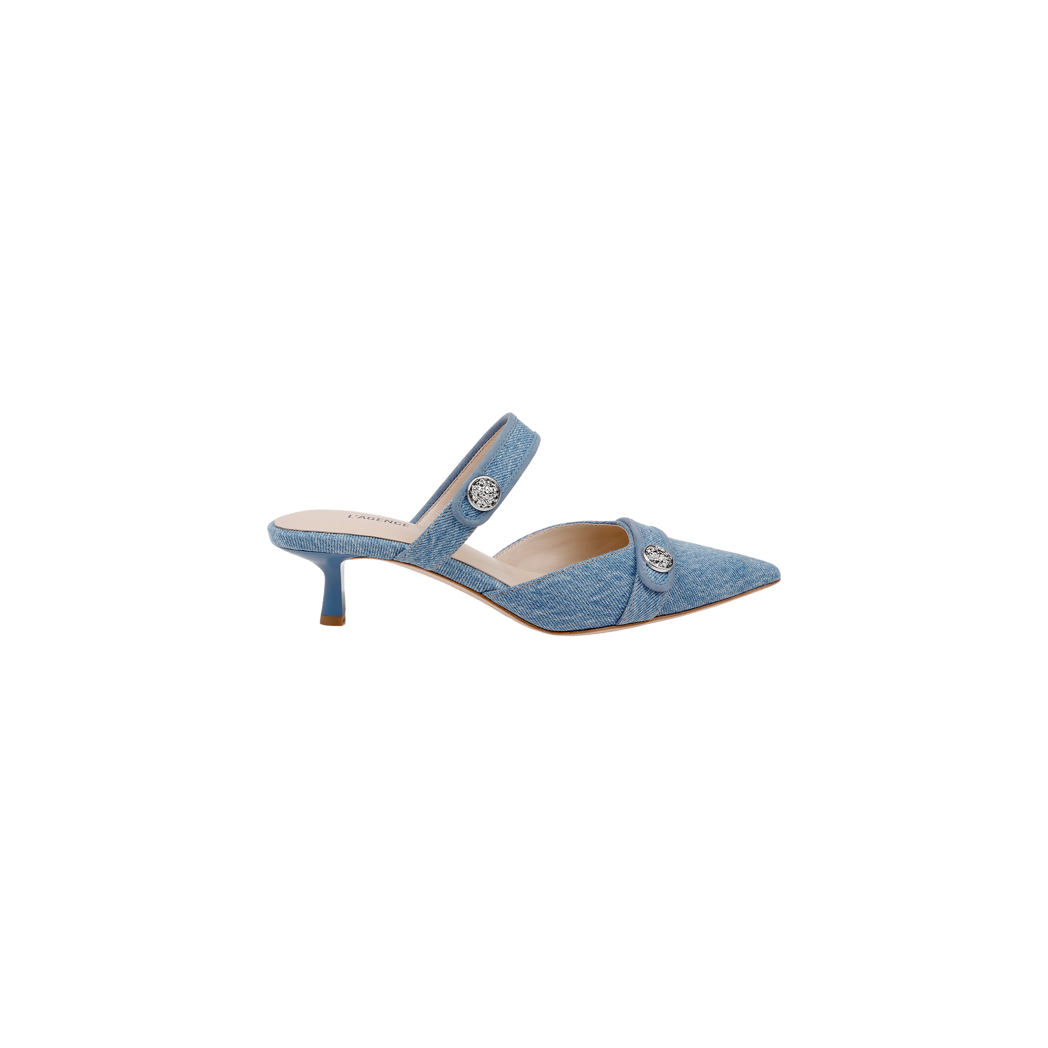 The Gilliane Denim Mule is showcased on a plain white background, featuring light blue denim material, a pointed toe, low kitten heel, two straps adorned with silver button details, a memory foam insole for added comfort, and a tan sole.