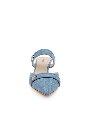 Front view of the Gilliane Denim Mule in blue denim, featuring a pointed toe, low heel, ankle strap with metallic accents, and a memory foam insole for comfort, displayed on a white background.