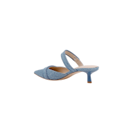 Gilliane Denim Mule in light blue features a pointed toe, crisscross strap across the front, memory foam insole, and a mid-height stiletto heel, shown on a white background.