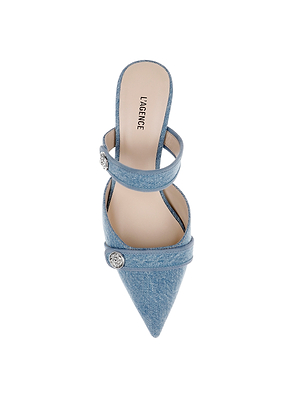 The Gilliane Denim Mule is a light blue pointed toe shoe with two strap details, each adorned with a silver button. It features a beige memory foam insole printed with LAGENCE for added comfort.