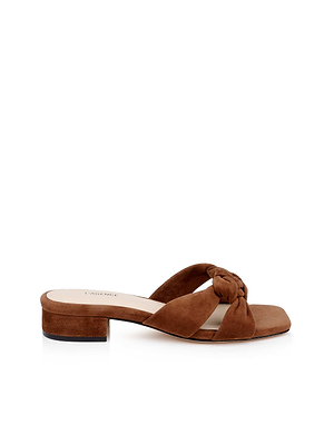 The Lea Suede Knot Sandal is a brown slide featuring a thick knotted strap, low block heel, and memory foam cushion for extra comfort, shown on a white background.