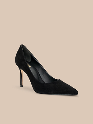 The Maelle Suede Pump features a pointed toe and sleek stiletto heel in classic black suede, elegantly showcased against a plain beige background.