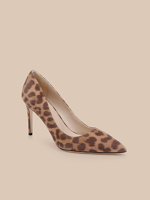 The Maelle Suede Pump is a classic pointed-toe shoe with a sleek stiletto heel, clad in brown and tan leopard print suede, shown against a plain beige background.