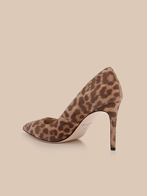 The Maelle Suede Pump is a single classic stiletto with a pointed toe, crafted from brown and tan leopard print suede, and displayed on a light beige background.