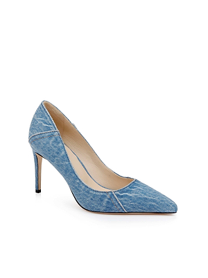The Maelle Denim Pump by L'AGENCE features a single pointed toe stiletto heel, covered in light blue denim fabric and displayed against a white background.