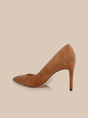 The Maelle Suede Pump is a light brown classic shoe with a stiletto heel and pointed toe, displayed in profile against a neutral beige background.
