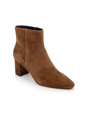 The L'AGENCE Melanie Suede Bootie features a brown suede finish, low chunky block heel, and slightly pointed toe, shown against a white background.