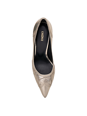 A top view of the Amandine Western Pump by L'AGENCE shows its metallic pointed toe, stiletto heel, and elegant swirl embroidery. The black insole features the gold-printed brand name L'AGENCE.