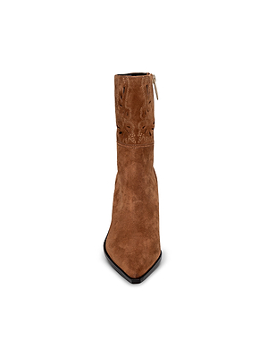 Front view of the Anne Western Bootie in brown suede, featuring decorative stitching near the top, a pointed toe, and a side zipper. This stylish Western boot is displayed centered on a white background.