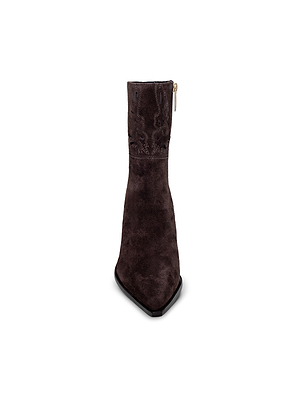 Front view of the Anne Western Bootie, a dark brown suede bootie with a pointed toe and side zipper, inspired by classic Western style, shown against a white background.