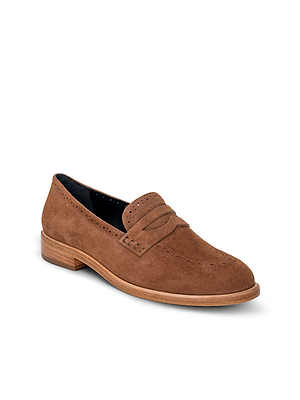 The Avriel Brogue Loafer is a tan suede loafer with decorative brogueing, perforations, a low wooden heel, and an almond toe, shown on a white background.