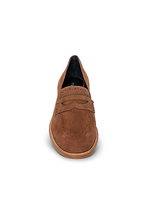 The Avriel Brogue Loafer in tan suede is shown from the front on a white background, featuring decorative stitching, an almond toe, and a strap detail.