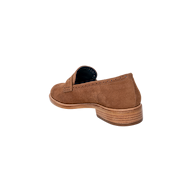 The Avriel Brogue Loafer in brown tan suede is shown from the back left angle, highlighting its almond toe design, wooden heel, and detailed stitching against a plain white background.