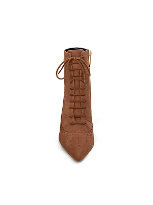 The Fayette Lace-Up Bootie is a brown suede ankle boot with a pointed toe, memory foam insole, and vintage-inspired brogue perforations, shown from the front on a white background.