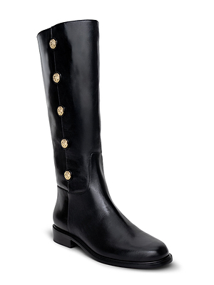 The Oceana Riding Boot by L'AGENCE is a tall black leather boot with a low heel and five gold lion-embossed buttons along the outer upper side.