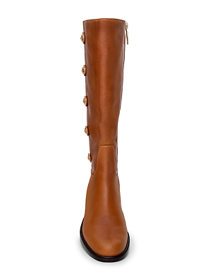 Front view of the Oceana Riding Boot, a tall cognac leather boot featuring decorative lion-embossed buttons along the side, a top back zipper, smooth finish, and rounded toe.