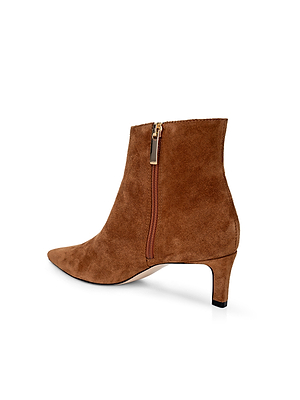 The Lilly Kitten-Heel Bootie is a brown suede city boot with a pointed toe, low kitten heel, and side zipper for closure, shown against a white background.