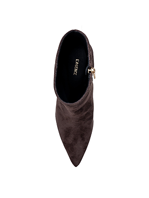 A top view of the dark brown suede Lilly Kitten-Heel Bootie by L’AGENCE, featuring a pointed toe, kitten heel, side zipper, and black insole with L’AGENCE gold lettering, displayed on a white background.