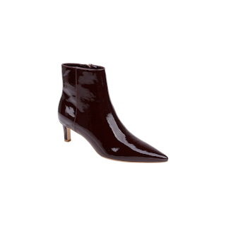 The Lilly Kitten-Heel Bootie is a single dark burgundy patent leather city boot featuring a pointed toe, mid-height kitten heel, and side zipper, displayed on a plain light background.